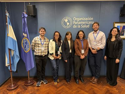A group of five people including Spencer Fox stand in front of the Organización Panamericana de la Salud