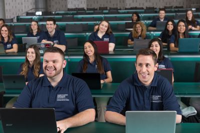 NAU Physician Assistant Studies students smile during a class on campus.