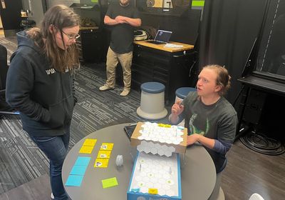 A Playful Health Technology lab student explains tech to a client.