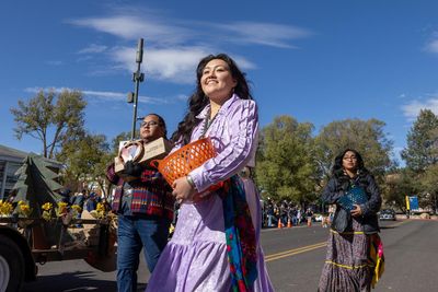 Indigenous students carry woven baskets in the N A U Homecoming Parade.