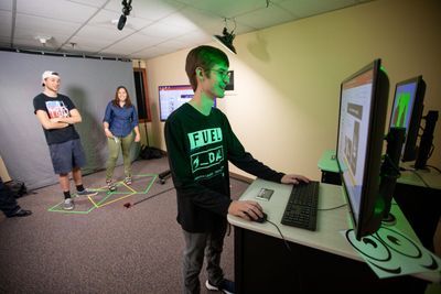 Students collaborate on a presentation in the One Button studio located in the Cline Library at NAU.