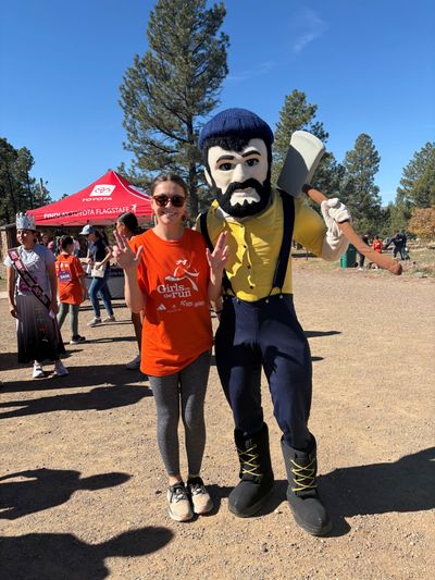 Rachel Kanyur stands with Louie the lumberjack at a volunteer event.
