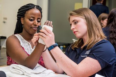 An NAU occupational therapist student works with a patient.