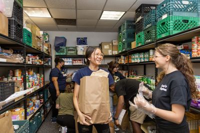 Students pick up groceries from a Louie's Cupboard food distribution event.