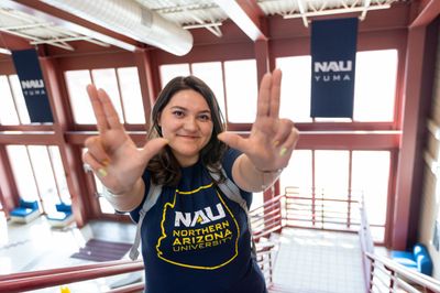 NAU-Yuma student, Katany Cardenas throws up the lumberjack L J's with her hands.