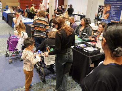 Community members visit vendor tables