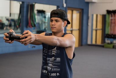 A N A U athlete holding a dumbbell doing athletic training at the gym.