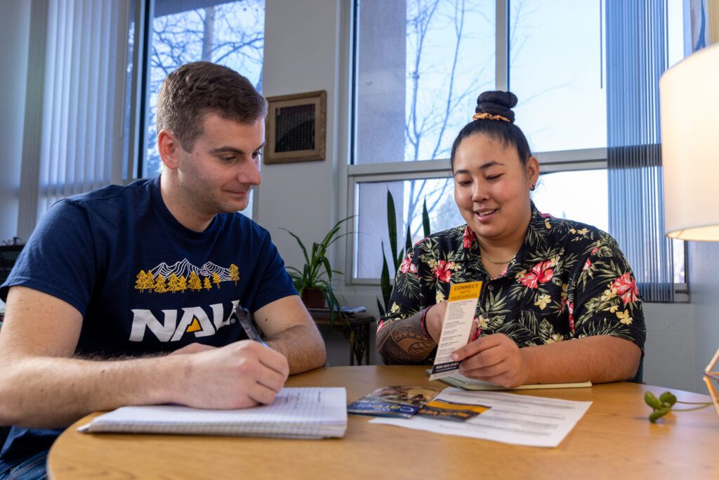 A student works with a writing assistant at the Lumberjack Writing Center on NAU campus.