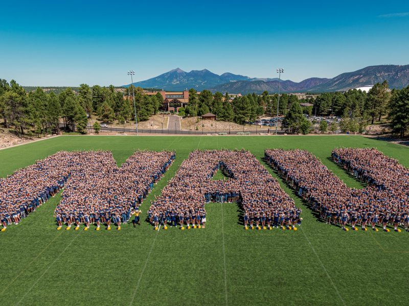Freshmen stand together to form the NAU letters during orientation