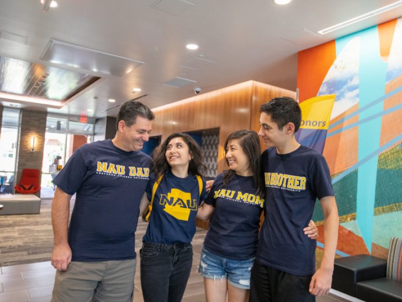 A family dressed in NAU attire proudly supporting their freshman.