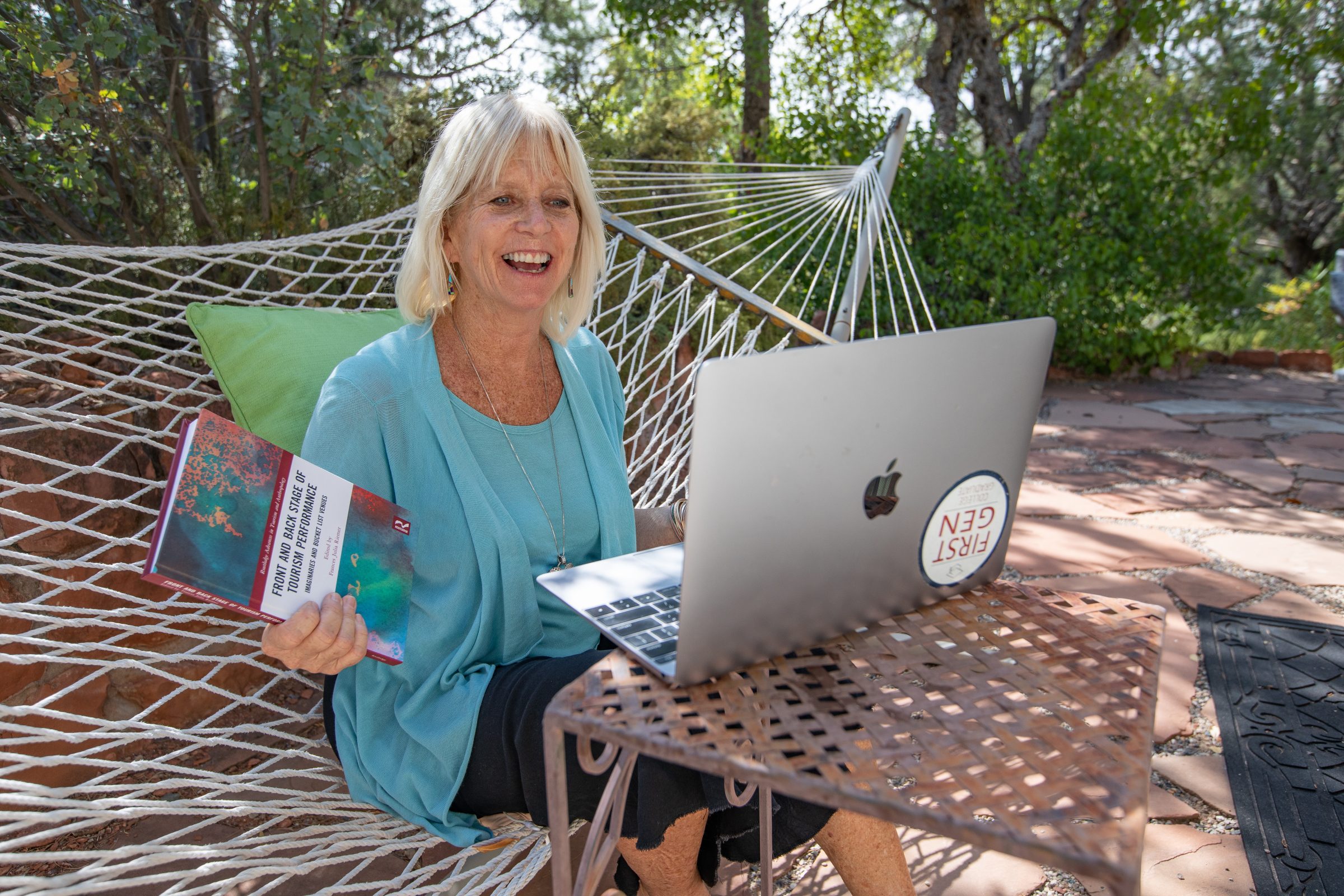 Instructor teaches class virtually from a hammock outside.