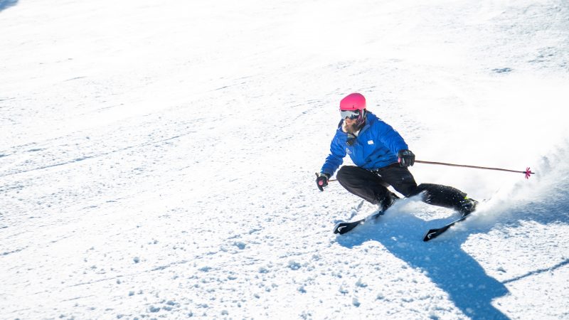 A person skiing down a snowy mountain.