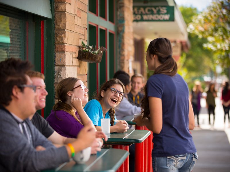 Students laugh at a restaurant in downtown Flagstaff.