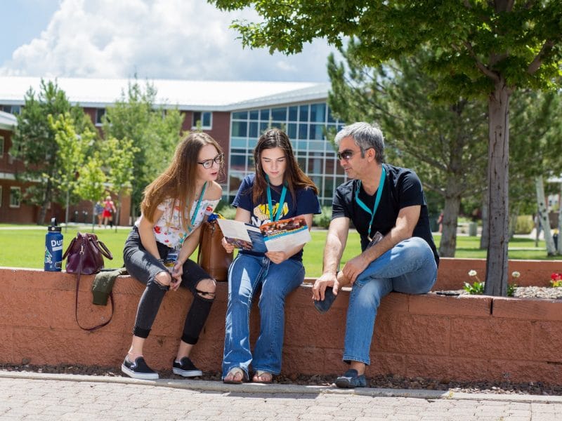Potential NAU family looking over transfer brochure.
