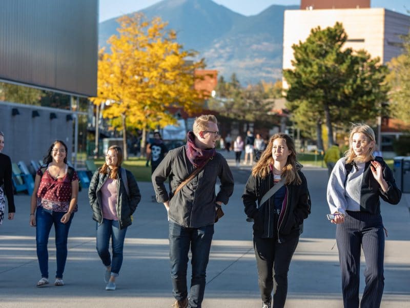 Students walking through NAU campus during fall.