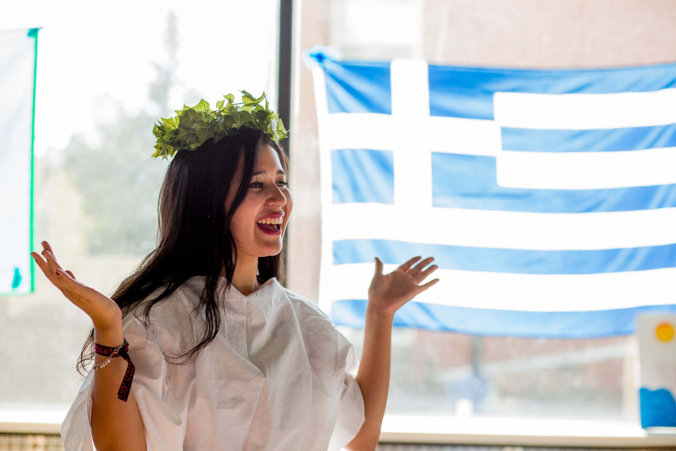 Student dressed in traditional Greek attire at international festival.