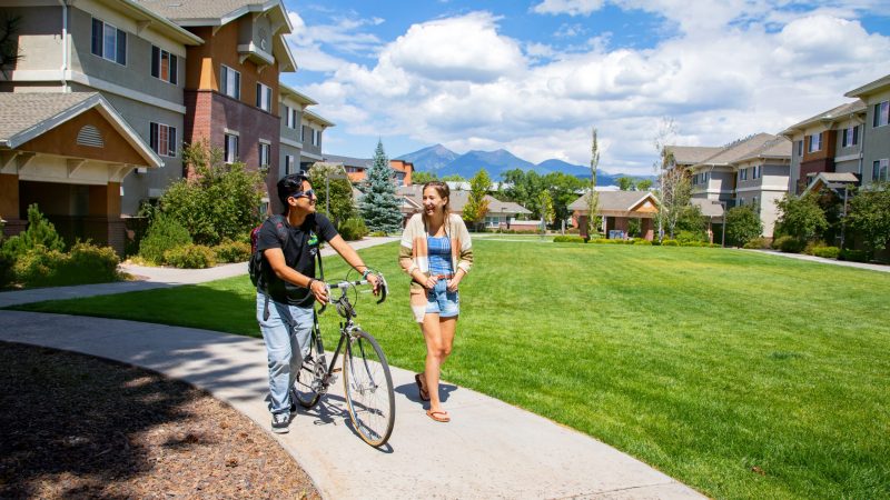Students walk together near residence hall on Flagstaff mountain campus.