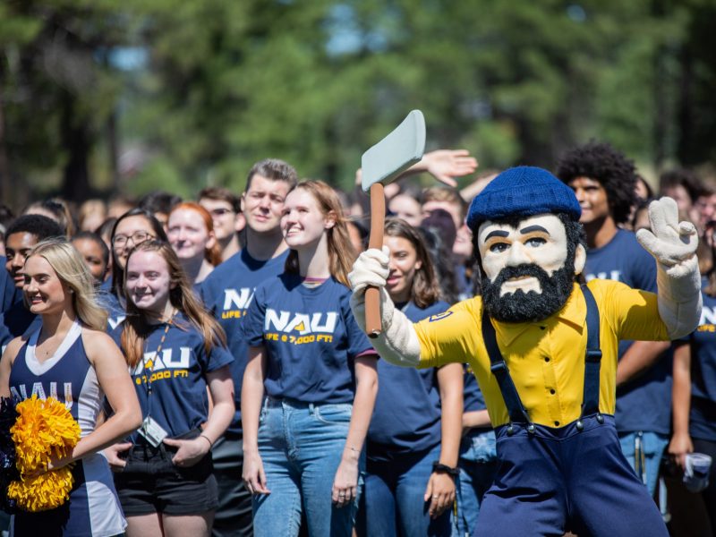 Students pose next to NAU mascot Louie the Lumberjack..