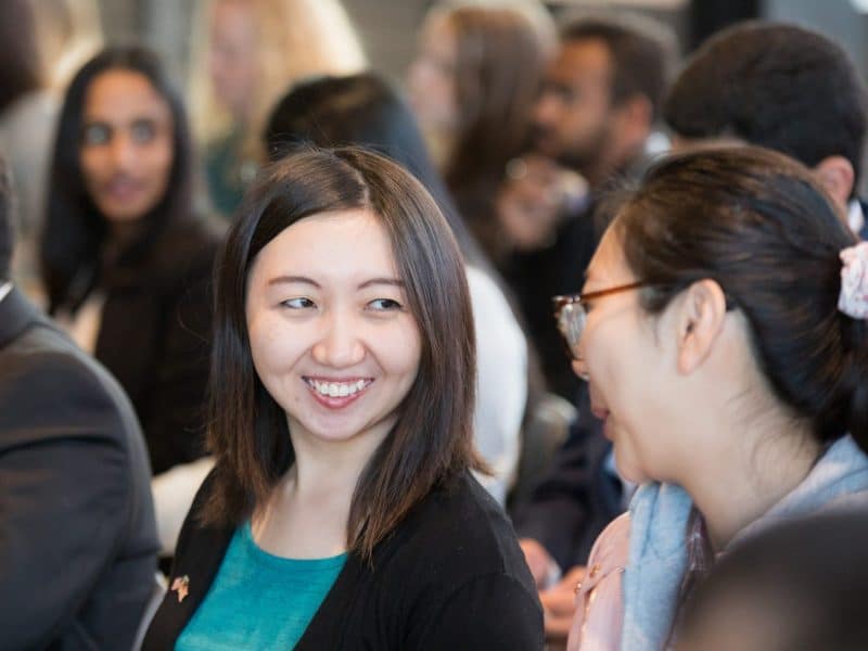 International students smiling and talking to each other at an International celebration.