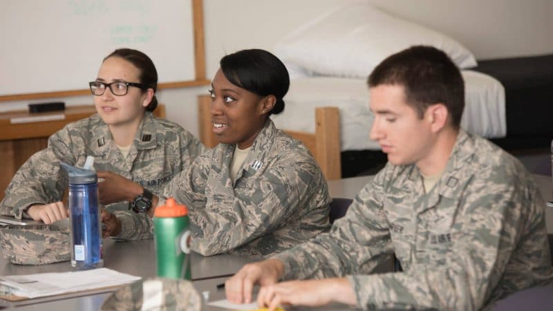 ROTC students sit together in a dorm room.