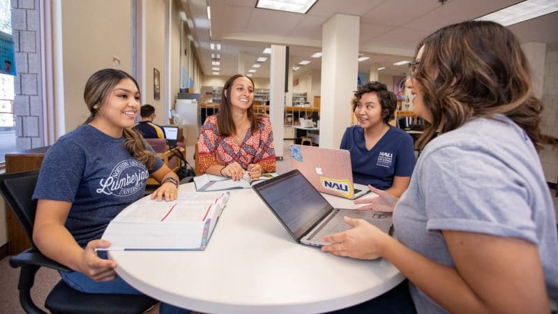 Students collaborating in the Yuma campus library.