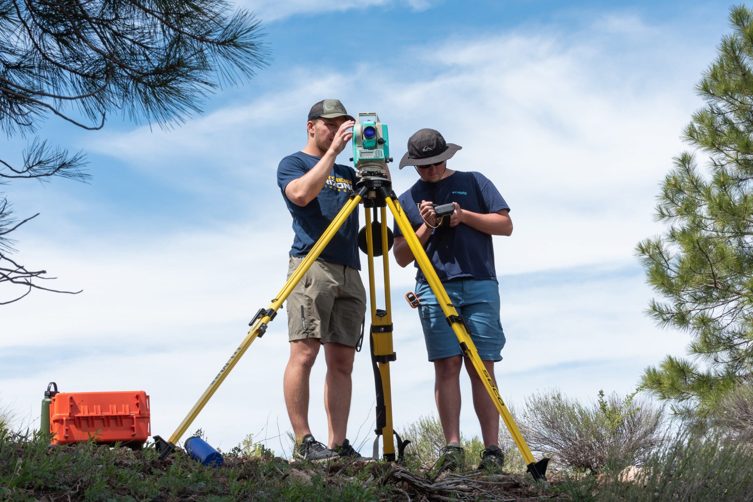 NAU students surveying with a large device outside.