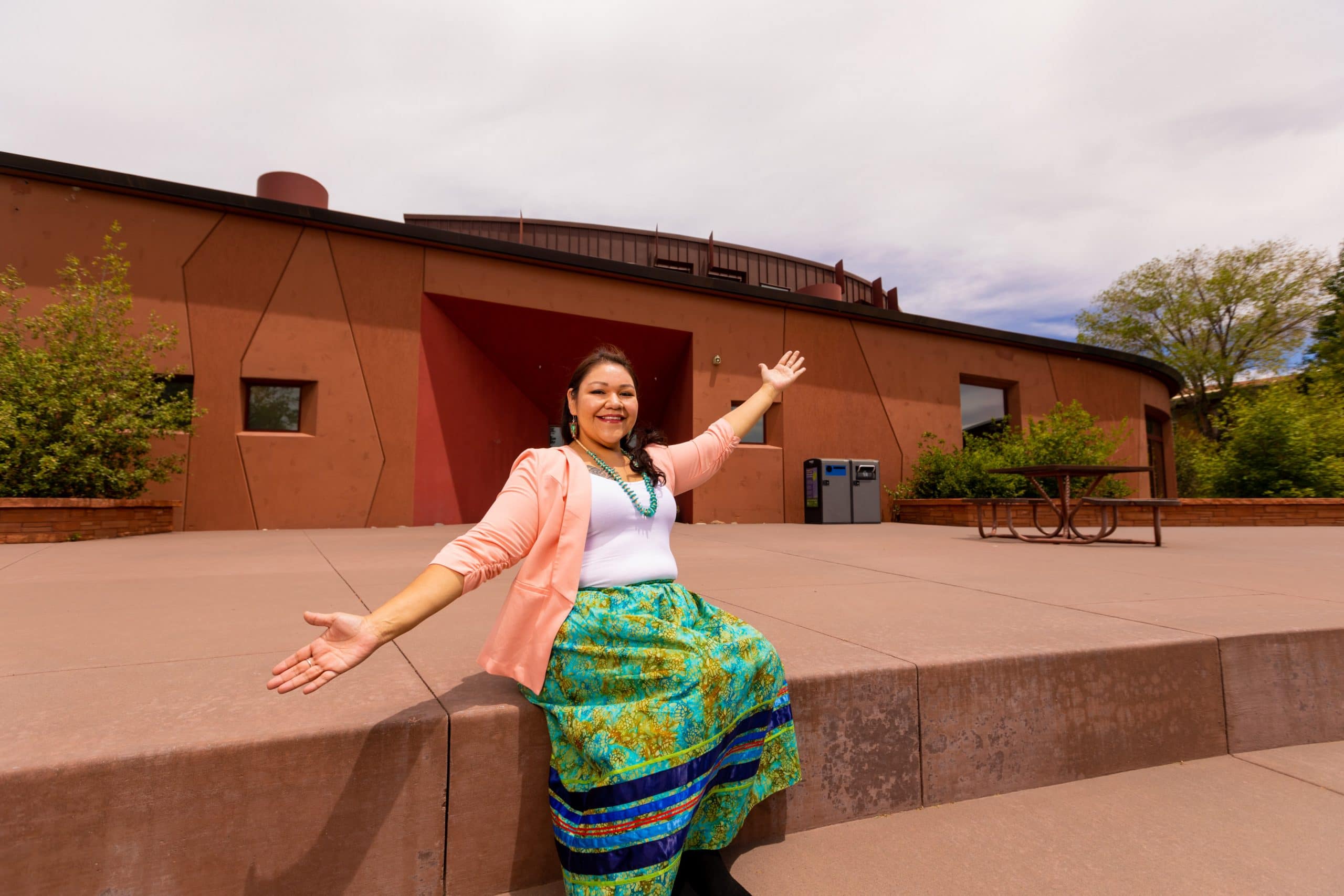 Ora Marek-Martinez sits in front of the NAU Native American Cultural Center