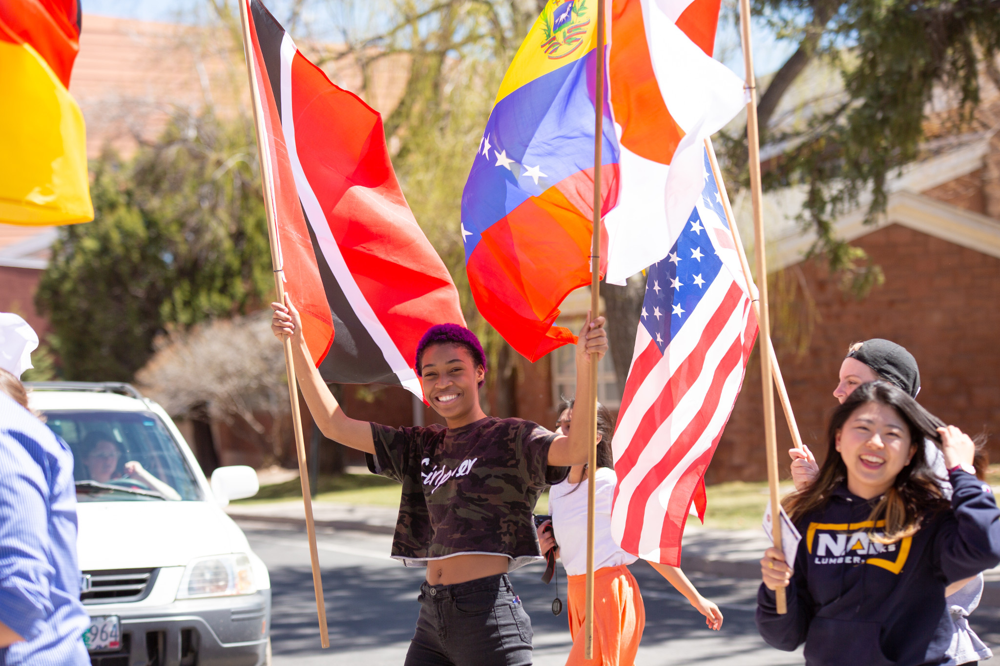 Student's smiling and marching with international flags.