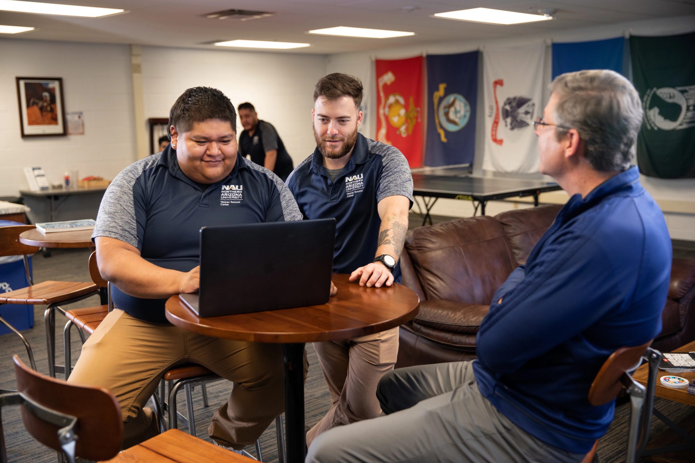 Veteran students working on a laptop in the Veteran Success Center.