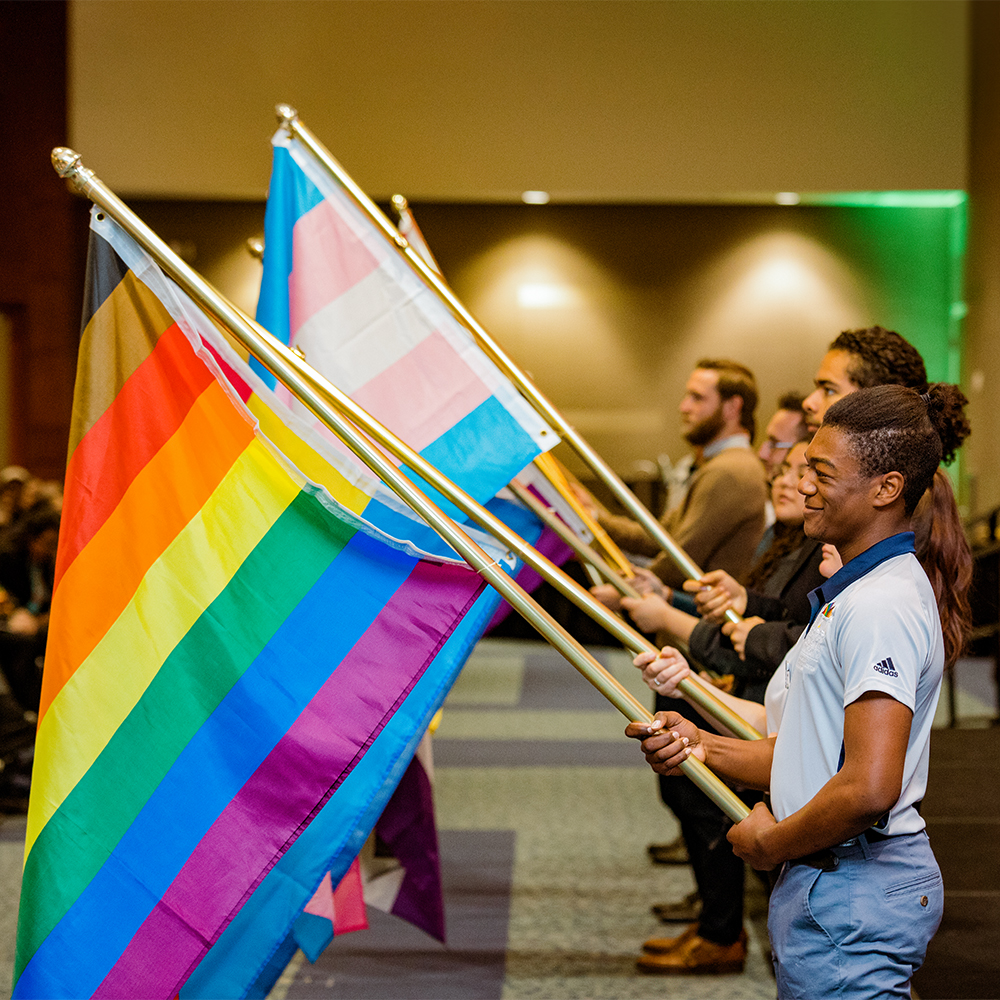 Students holding LGBTQIA+ pride flags in honor of Pride Month.