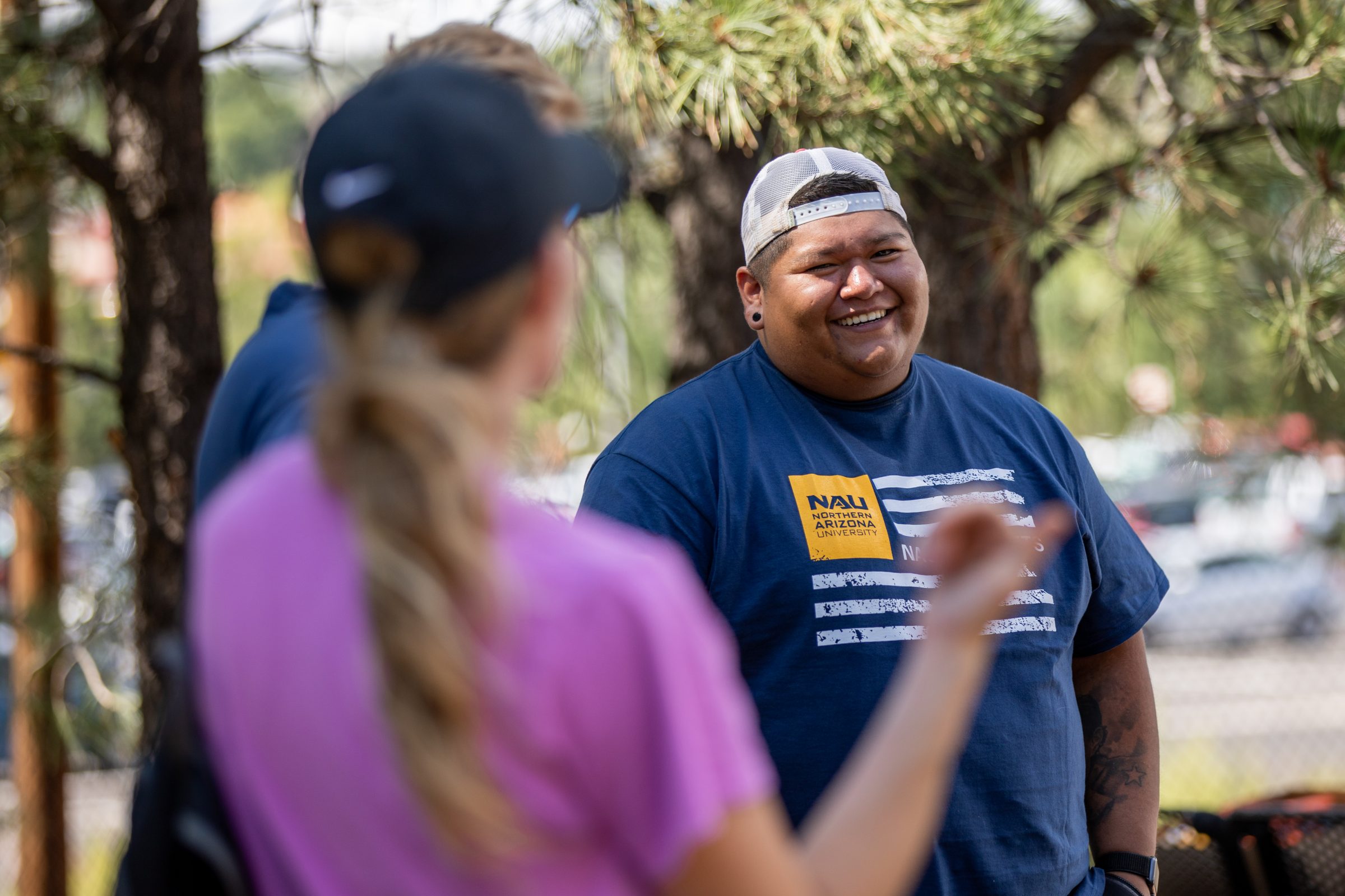 A student smiles while playing disc golf in Flagstaff