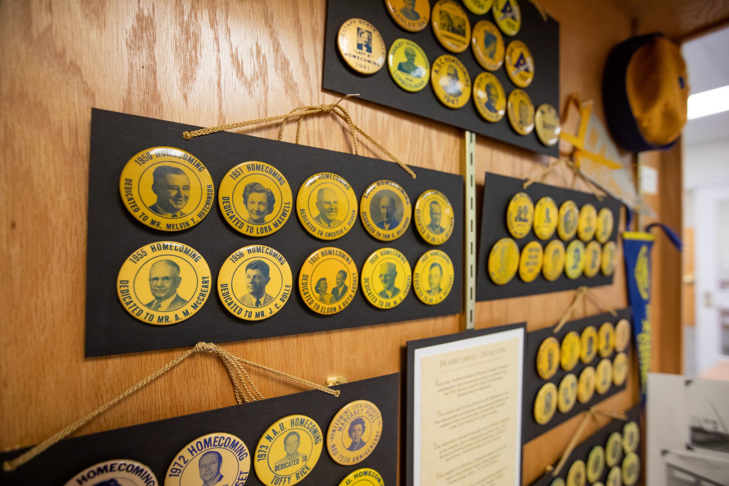 A wall of past dedicatees buttons.