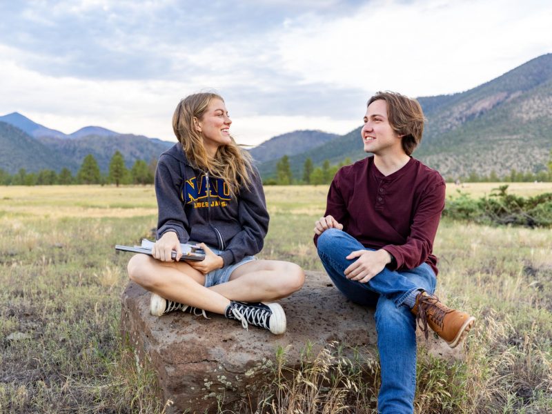 Two students sitting together at Buffalo Park.