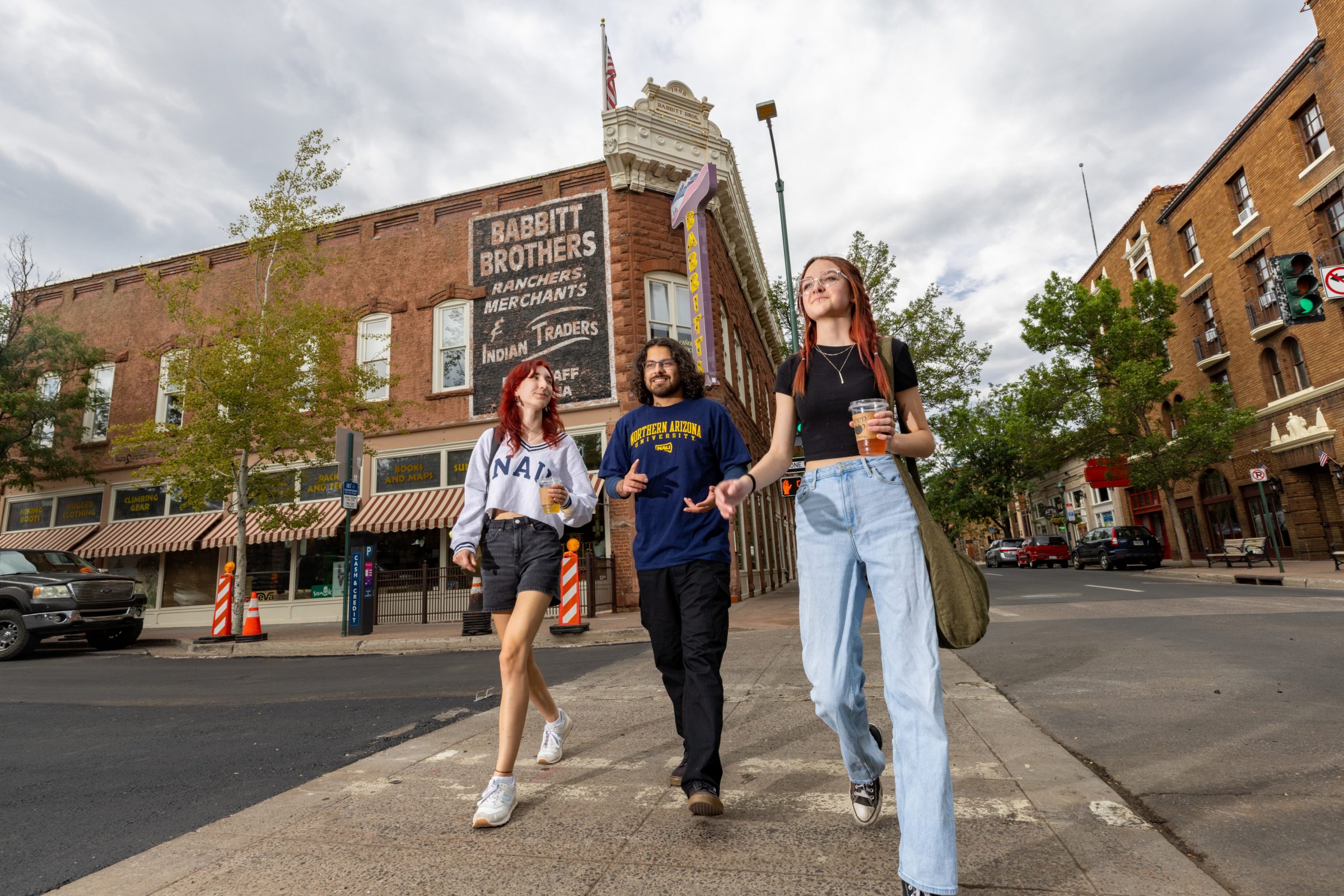 Three students walking in Downtown Flagstaff.