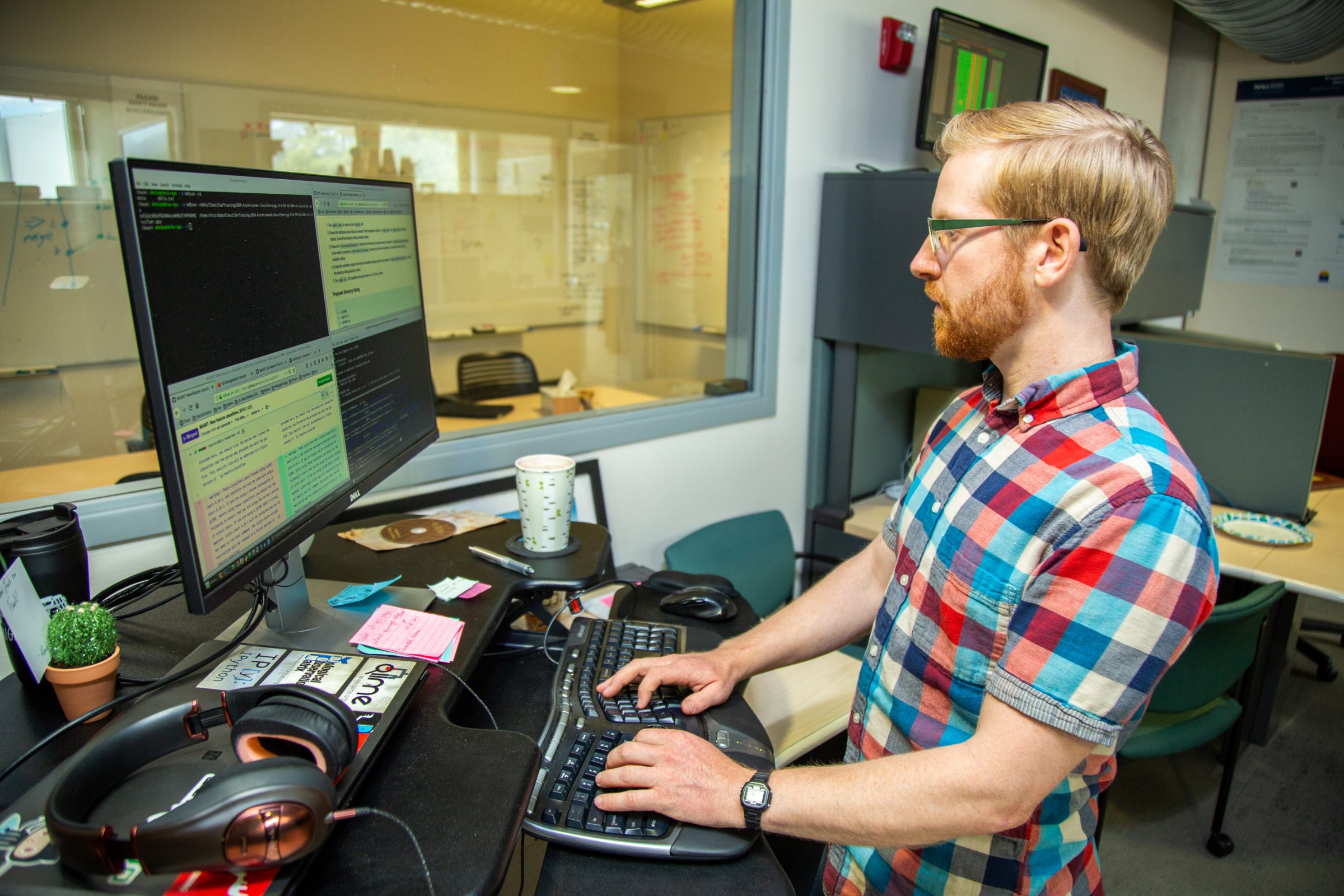 Software engineer professor writes code on a computer screen.