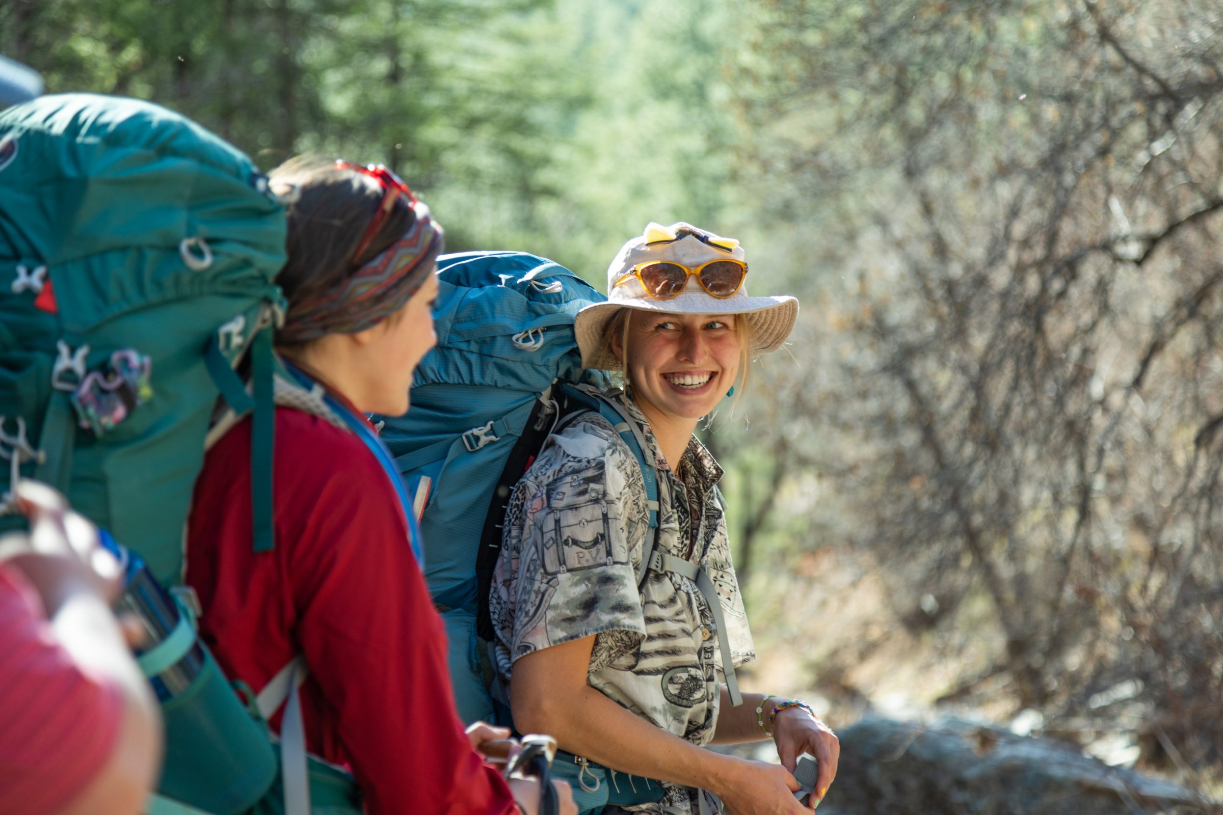 Two students backpacking together in the outdoors.