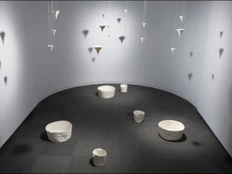 Installation entitled Metaphor for a Memory, featuring hanging ceramic funnels and washtubs, by Professor Jennifer Holt