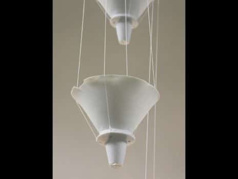 Close up of suspended ceramic funnels from the piece Metaphor for a Memory by Professor Jennifer Holt