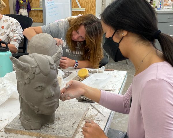 Students in Three-Dimensional Design sculpt in clay