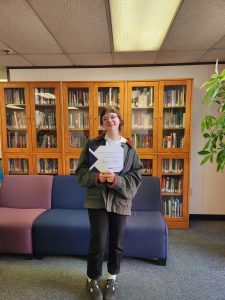 This image shows Joce Dolezal posing with her scholarship certificate.