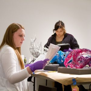 Student interns at the Clara M. Lovett Art Museum conduct condition reports in 2018.