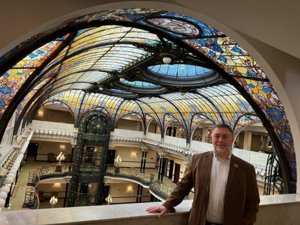 Dr. Cabrera Geserick poses in front of the stained glass ceiling of the Gran Hotel.