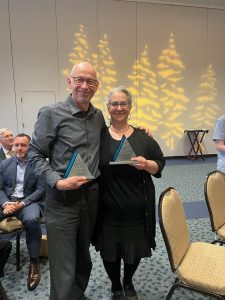 Professors Bjorn Krondorfer and Alexandra Carpino stand with their awards. 