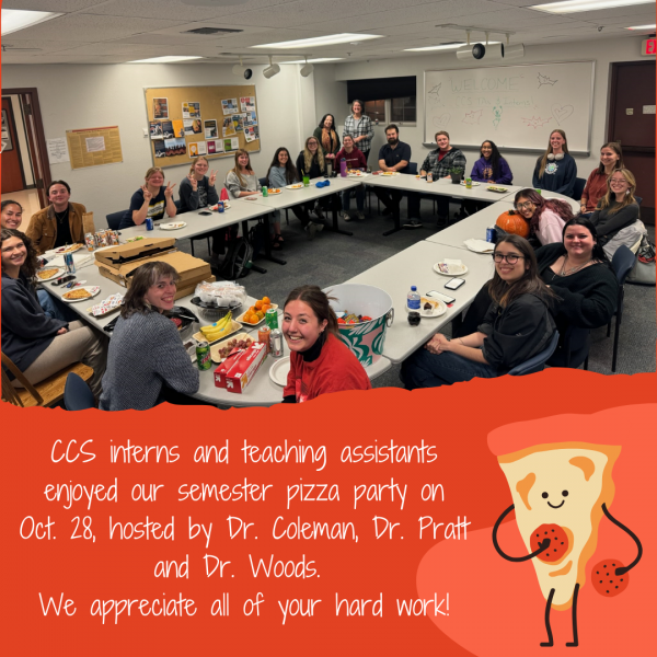 Image shows a group of students eating pizza in a classroom. The long description repeats the text. 