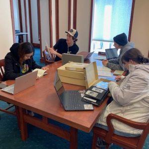 A group of students examining archival documents