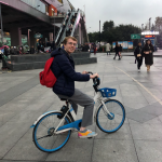 NAU student riding a bike in China.
