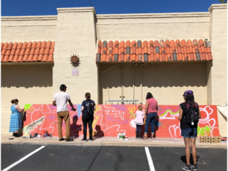 Students painting art outside.