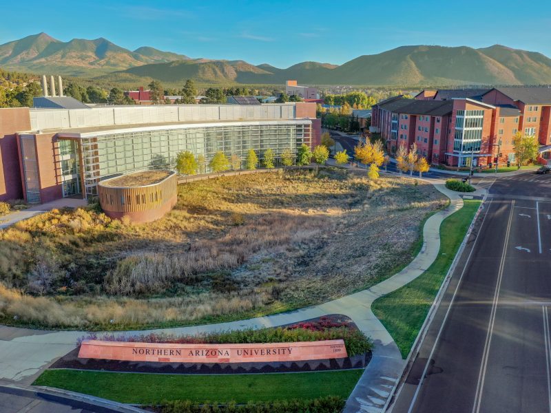 Aerial picture of NAU's Flagstaff campus with mountains in the distance.