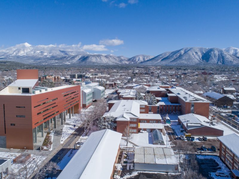 A snow covered Flagstaff campus captured from above.