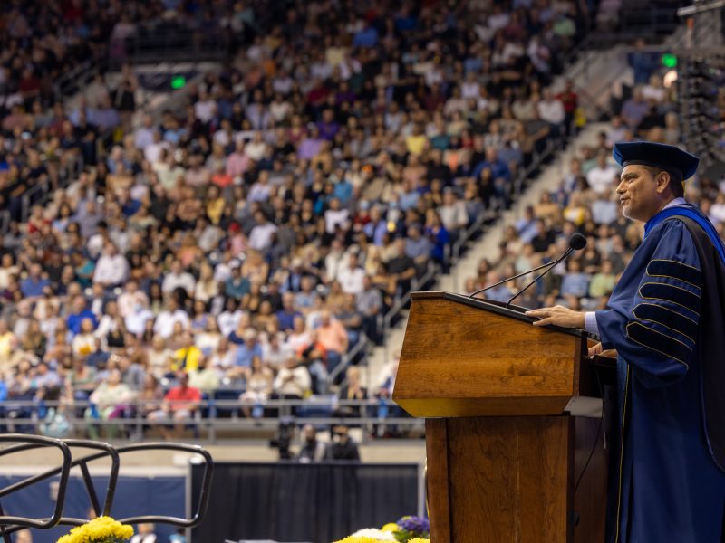 President Dr. Jose Luis Cruz Rivera speaks to a large crowd at commencement.
